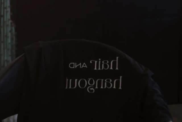 Hair and Hangout branded chair cover in a modern salon interior